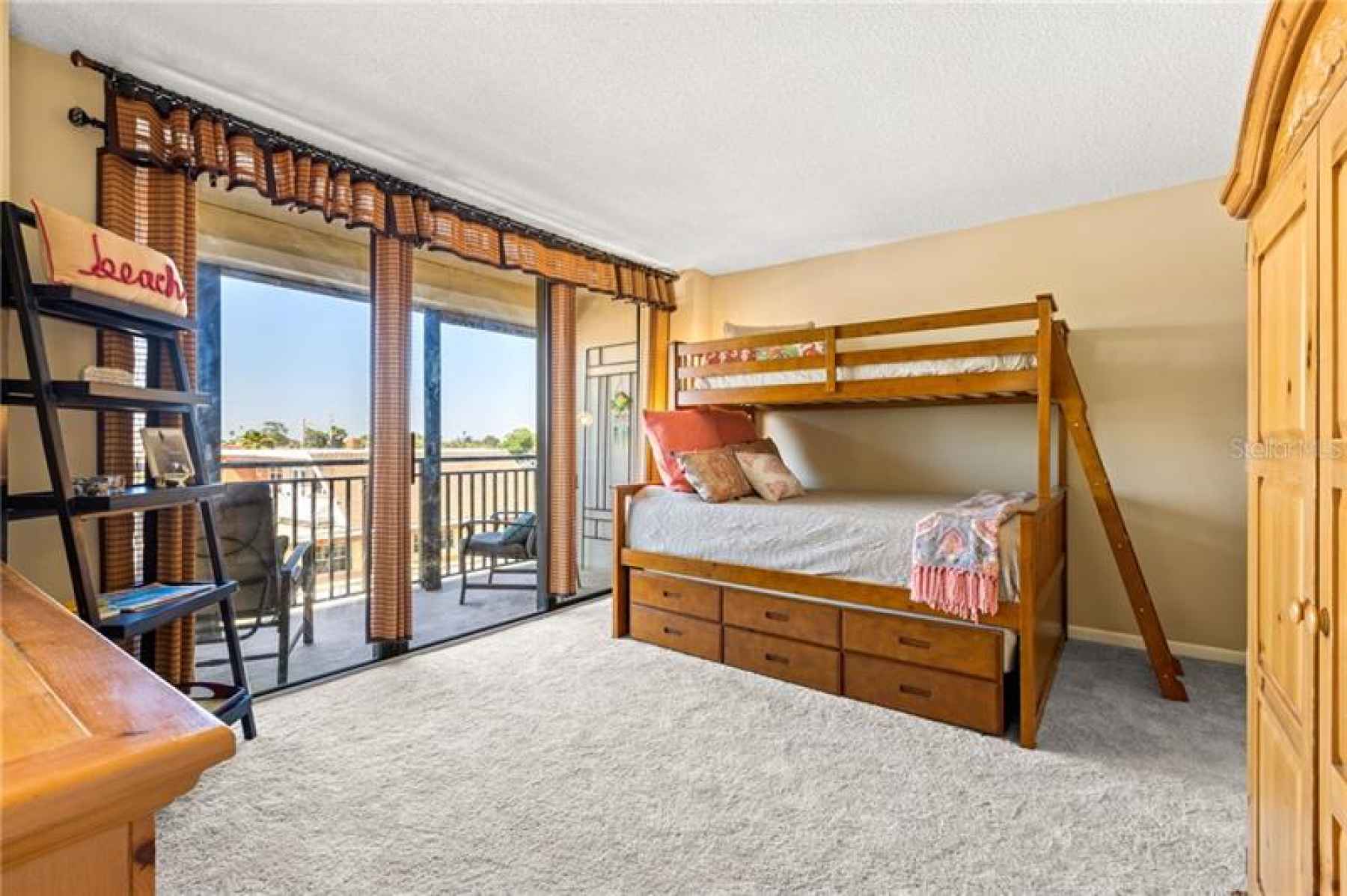 Guest en-suite and balcony featuring partial water views of the beach and intercostal.