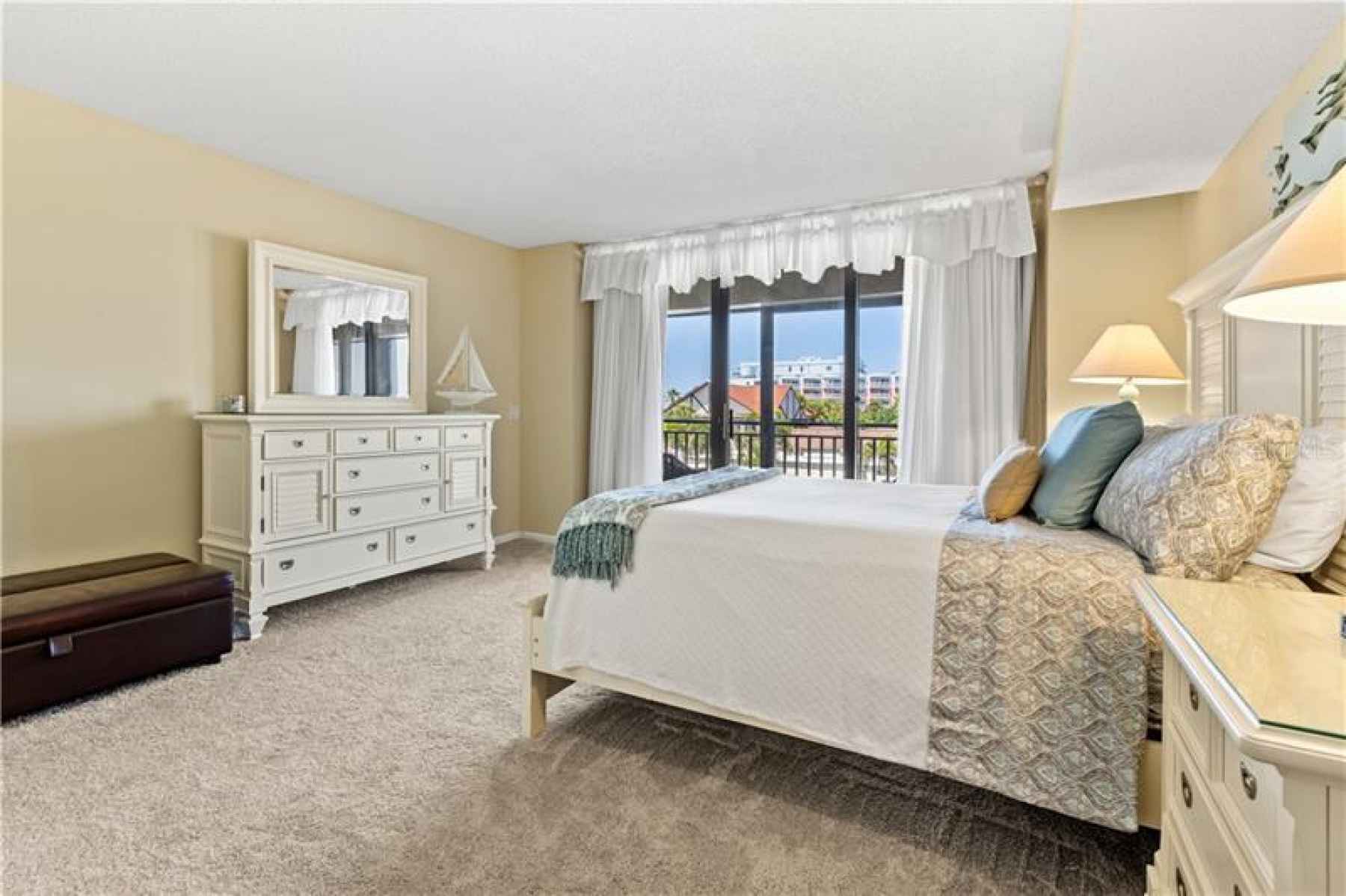 Master suite featuring beach views, sliding barn door, walk in closet, separate vanity area.