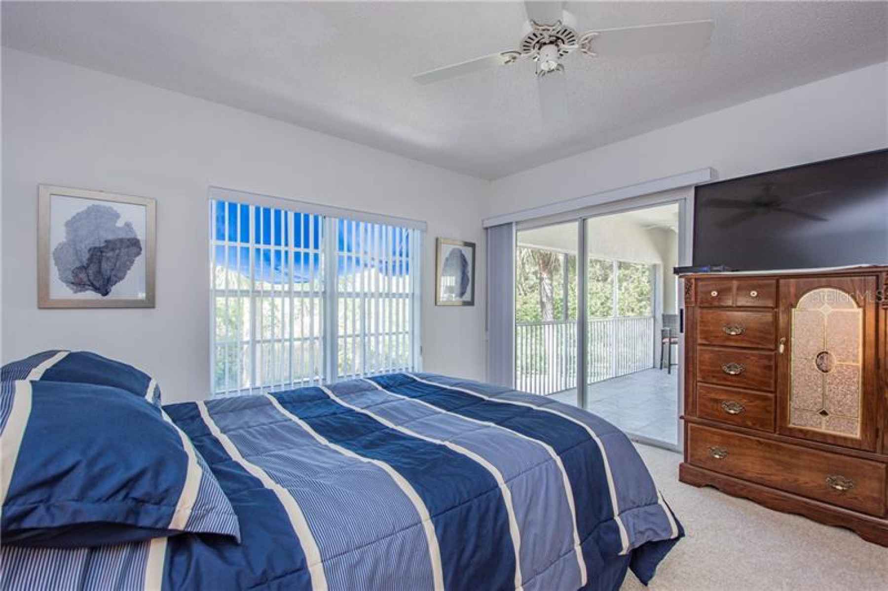 Master bedroom and sliding glass door to covered screened-in lanai