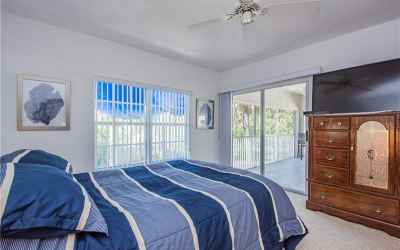 Master bedroom and sliding glass door to covered screened-in lanai