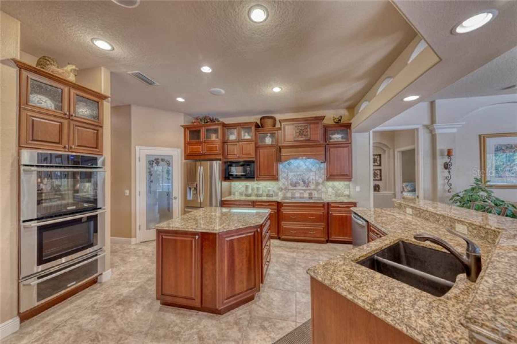 Kitchen... notice walk in pantry, double oven, warming drawer and ample storage space