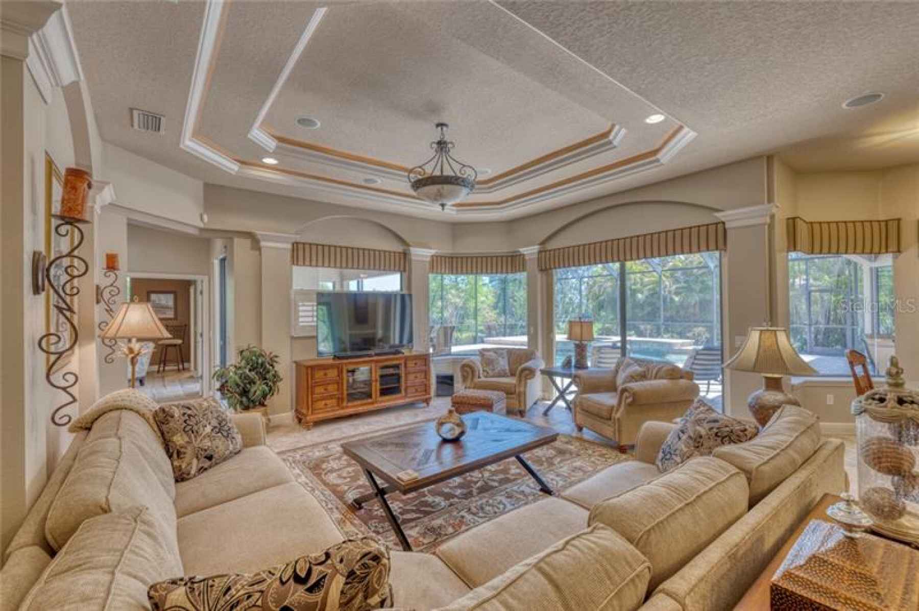 Large, open concept Family Room looking out over the pool and pond.