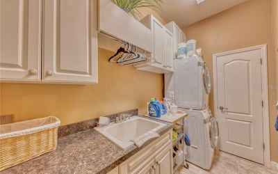 Laundry room with ample cabinet storage and large storage closet