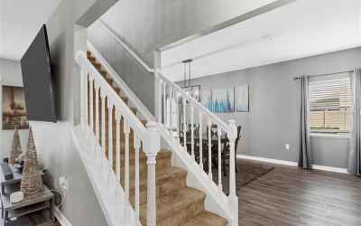 Stairs lead to 3 bedrooms + master suite, laundry & loft.