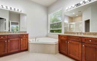 MASTER BATHROOM WITH ROMAN TUB & GRANITE COUNTER TOPS WITH UPGRADED CABINETS.