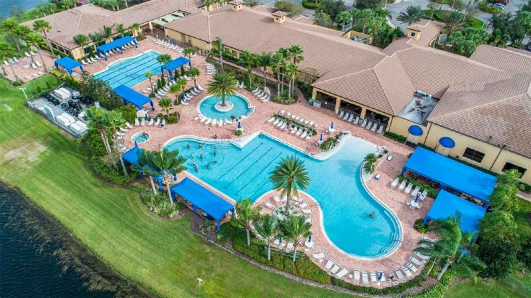 AERIAL VIEW OF 3 POOLS, HOT TUB AND CLUBHOUSE
