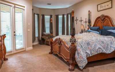 MASTER BEDROOM WITH SITTING AREA AND FRENCH DOORS TO BACK PORCH