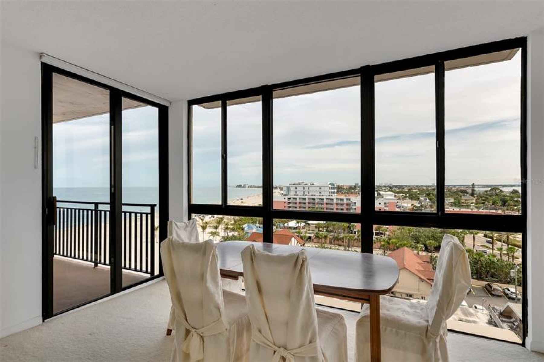 Views from the living room / dining area span west to east to show the beach, Gulf Blvd. and Boca Ci