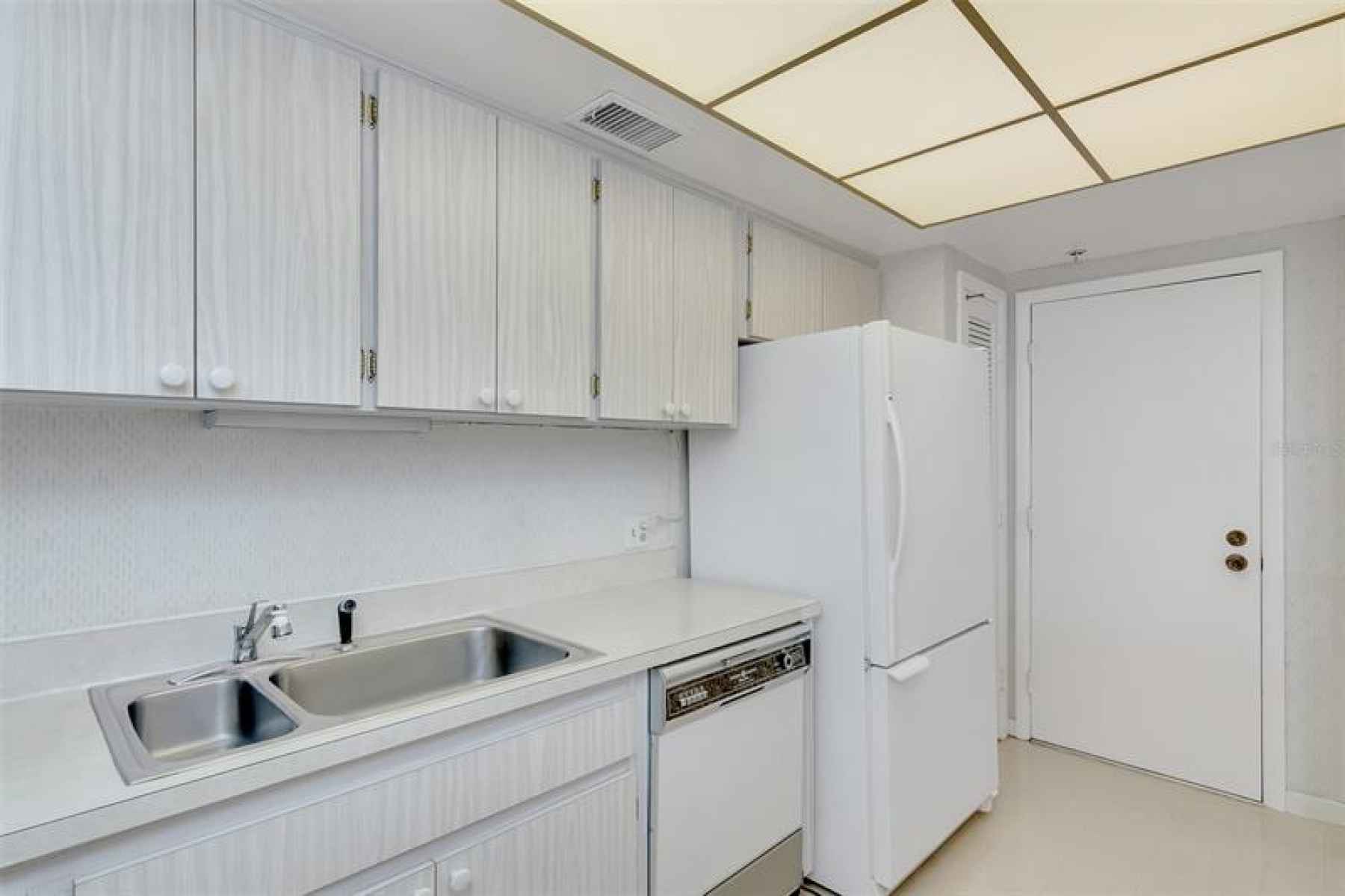 An extra doorway in the kitchen for easy access to take out trash, head to the laundry room, emergen