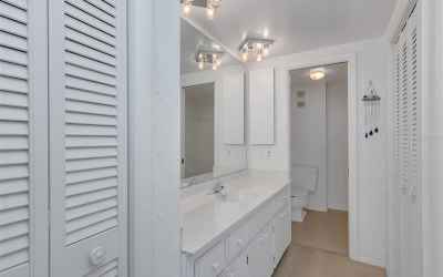 In the east bedroom, the en suite bath with spacious vanity area and multiple closets