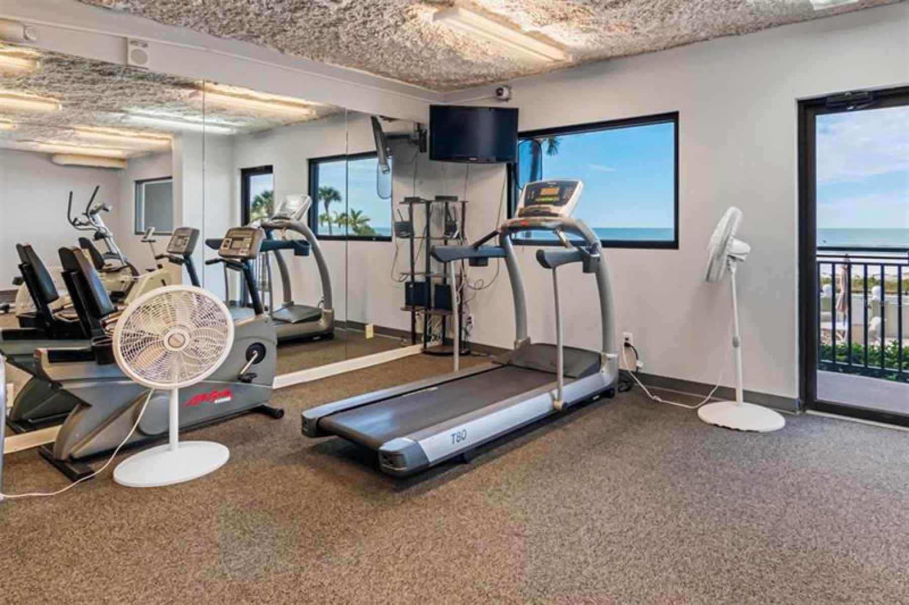 g23A well-stocked fitness room provides opportunity to work out while you enjoy the Gulf view