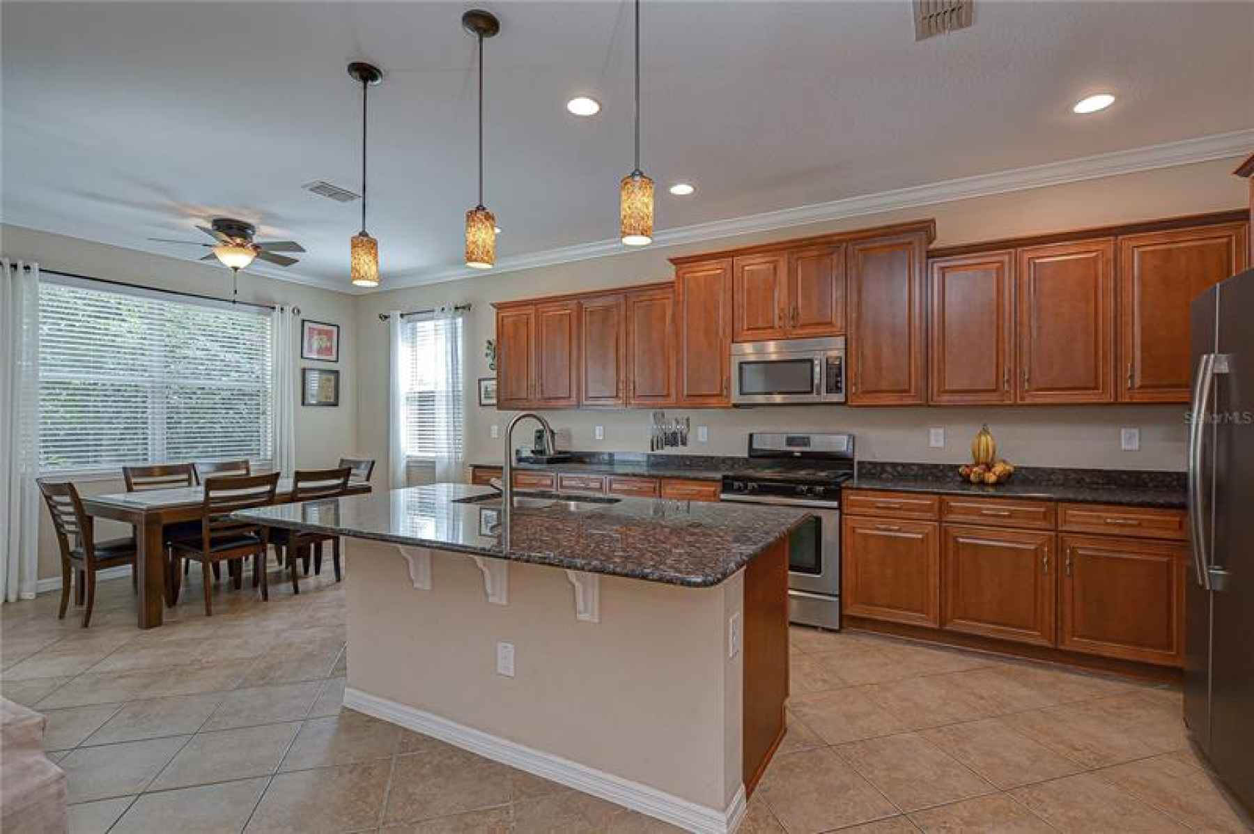 DREAMY kitchen offers so much storage space in the rich cherry cabinets topped with crown!