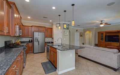 Granite counters, oversized center island, stainless appliances, and a built-in desk space all tie t