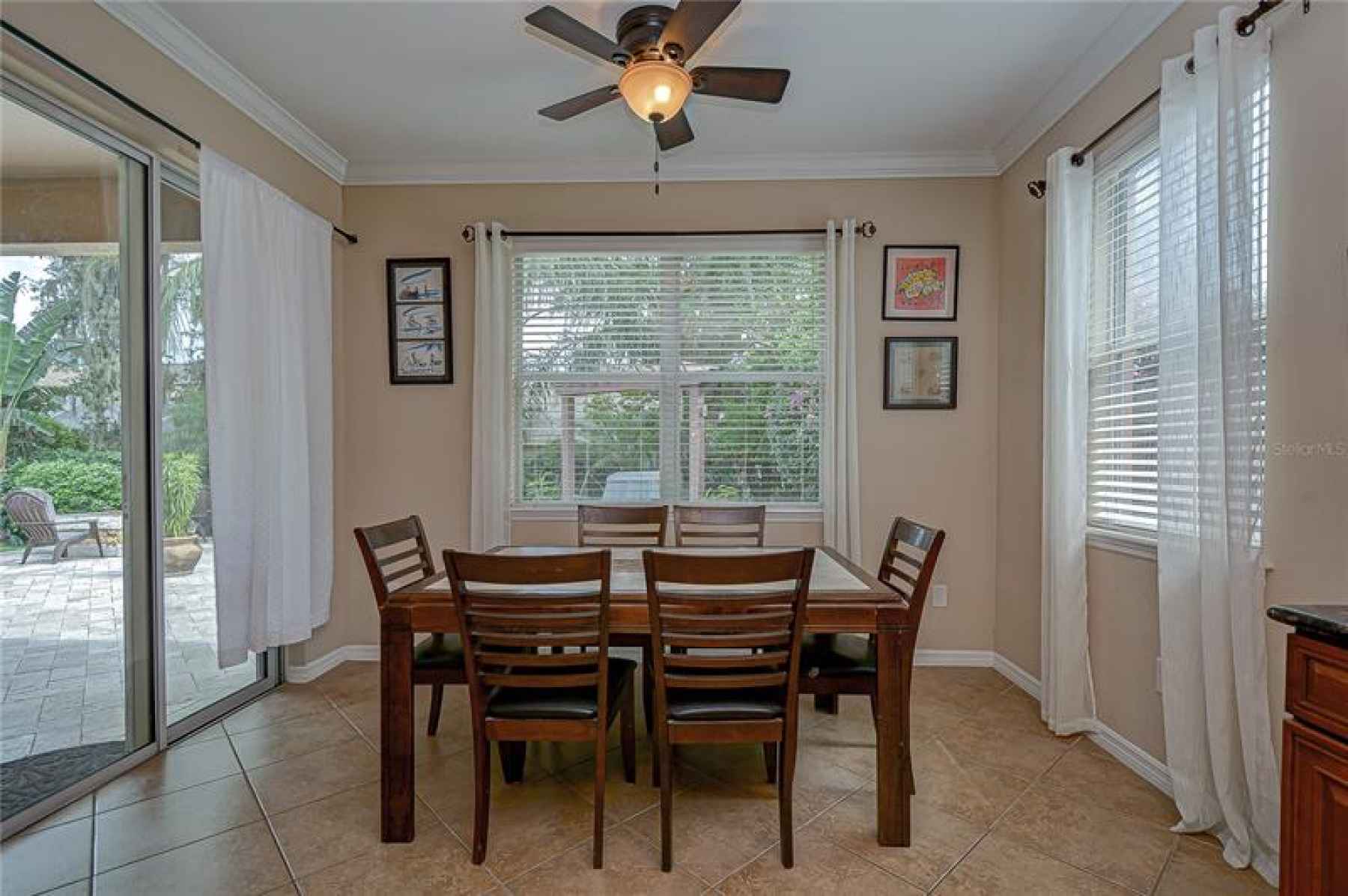 An open dining area is adjacent to the kitchen with sliders to the Oasis that awaits you outside!