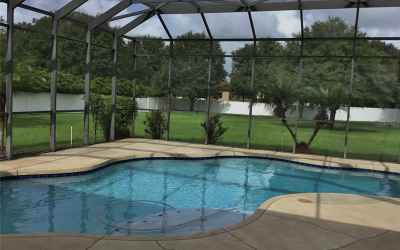Pool overlooking expansive backyard