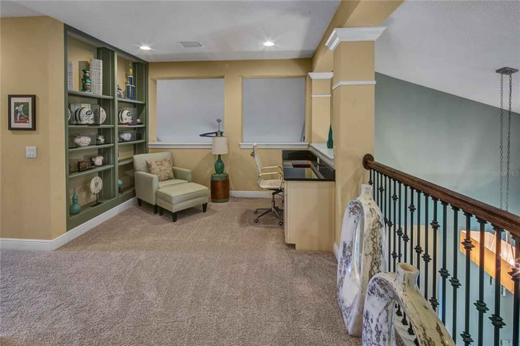 Study with built in book shelf and desk. Overlooking the Breakfast Nook and Family Room.
