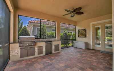 Screened in Lanai with custom built-in Grill, refrigerator and kitchen area.