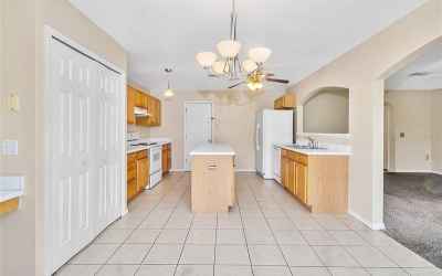 Spacious kitchen has abundant counterspace and cabinets, as well as large pantry.