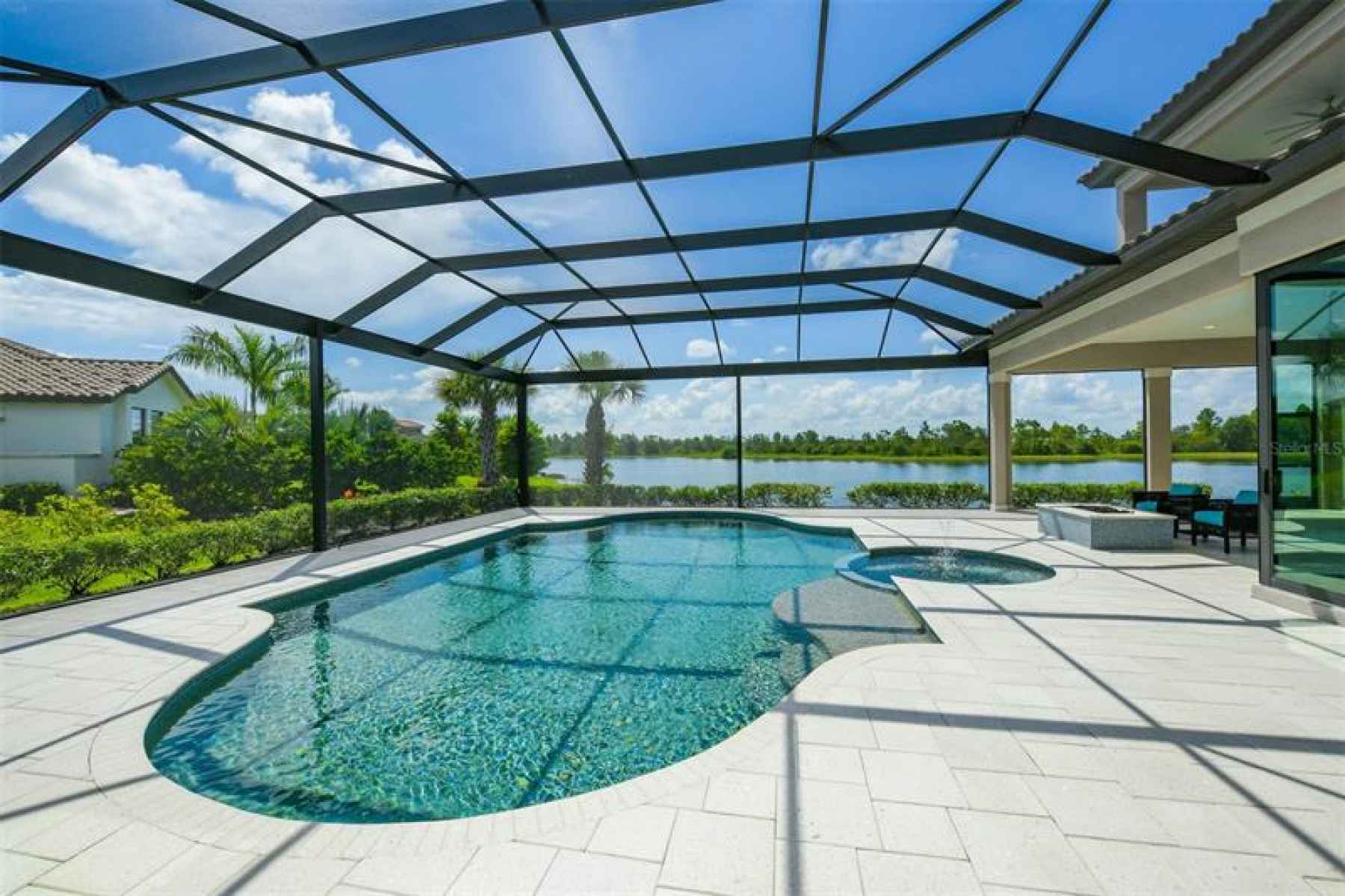 Heated pool & spa with sun shelf with panoramic screens for open lake views