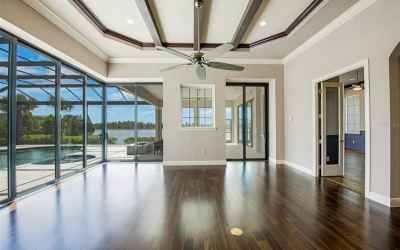 Family room with 90 degree sliders to the lanai and french doors to the bonus room