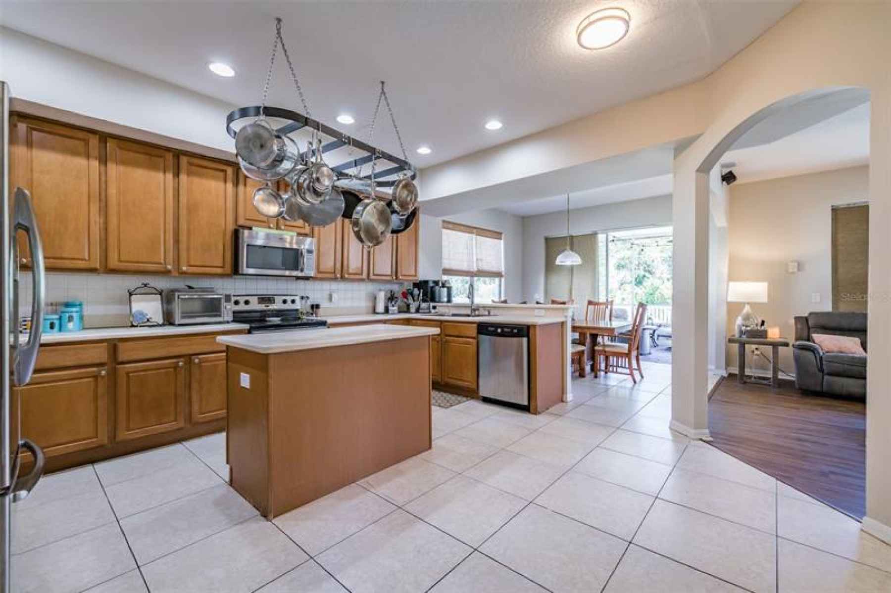 Spacious kitchen with island and pot rack