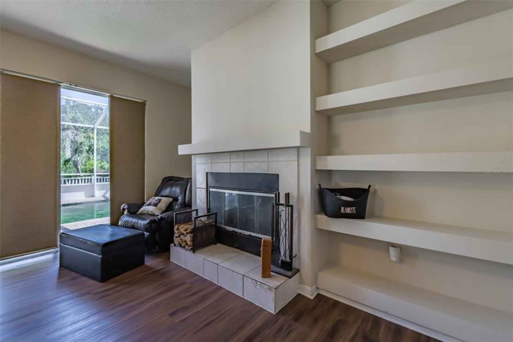 Wood burning fireplace and built in shelves in family room