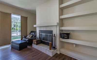 Wood burning fireplace and built in shelves in family room