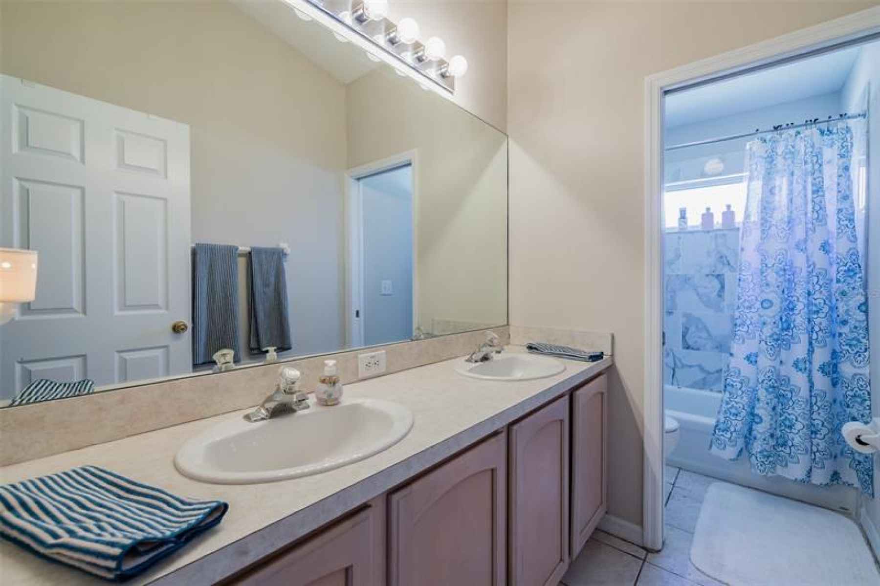 Bathroom 3 has dual sinks and tub/shower combo