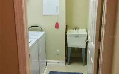 LAUNDRY ROOM WITH UTILITY SINK & EXTRA STORAGE