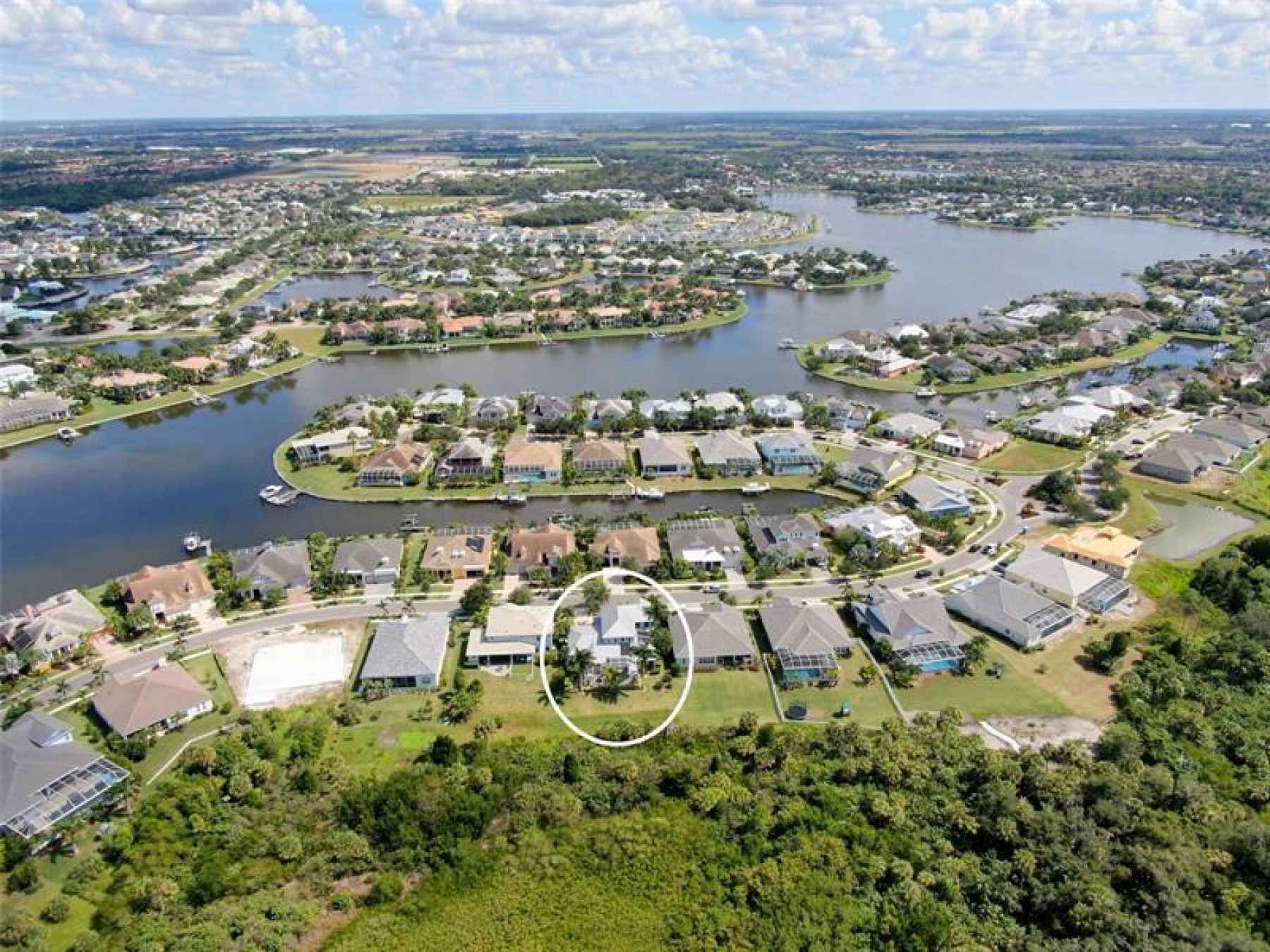 Aerial view of the Mirabay 136 acer lagoon.  Your home is located with in the circle.  Front door fa