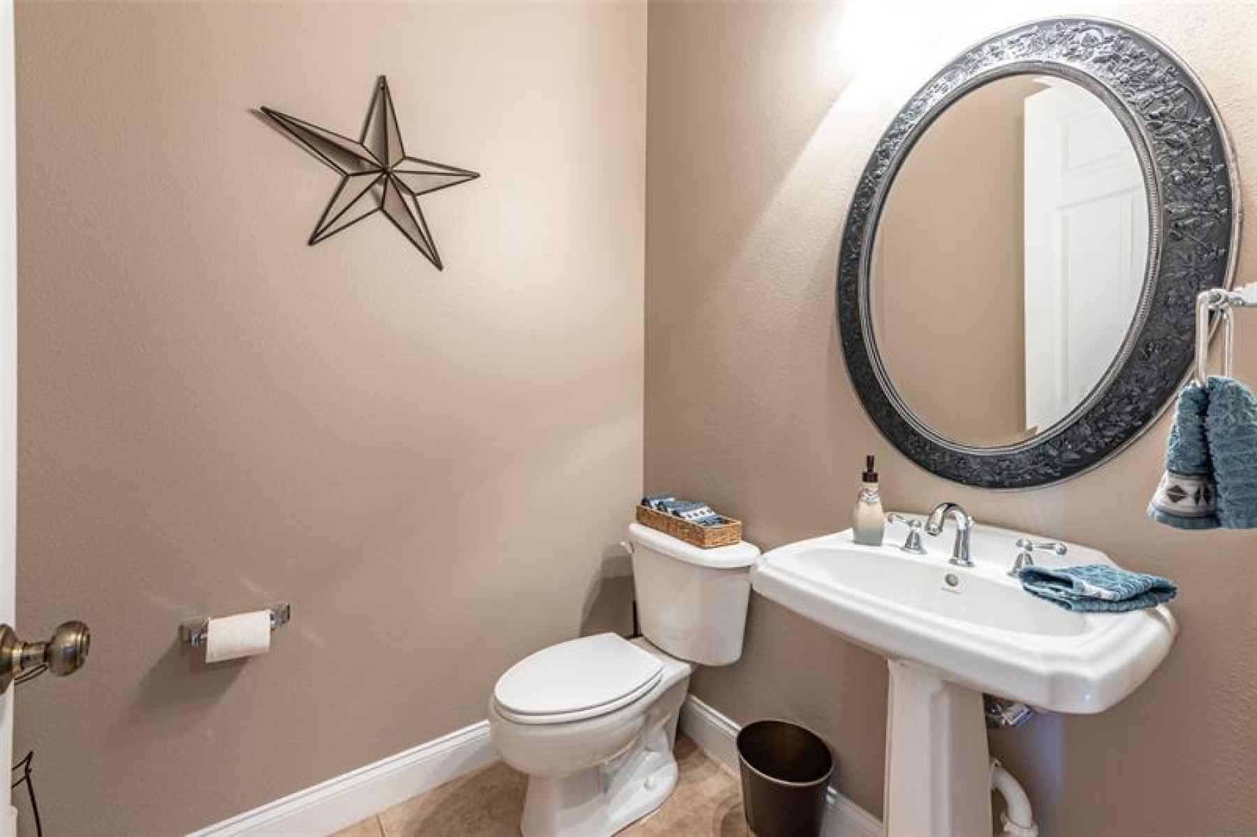 Guest half bath off foyer, close to home office and family room.