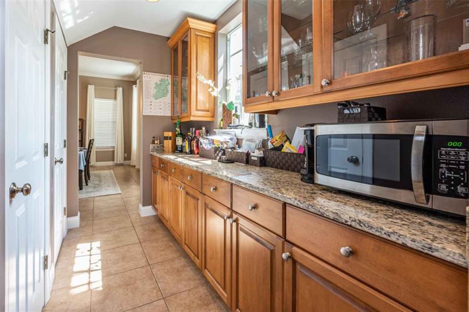Expansive butlers pantry running between the kitchen to the dining room.  Tons of cabinet space and 