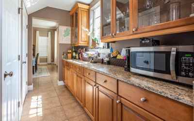 Expansive butlers pantry running between the kitchen to the dining room.  Tons of cabinet space and 