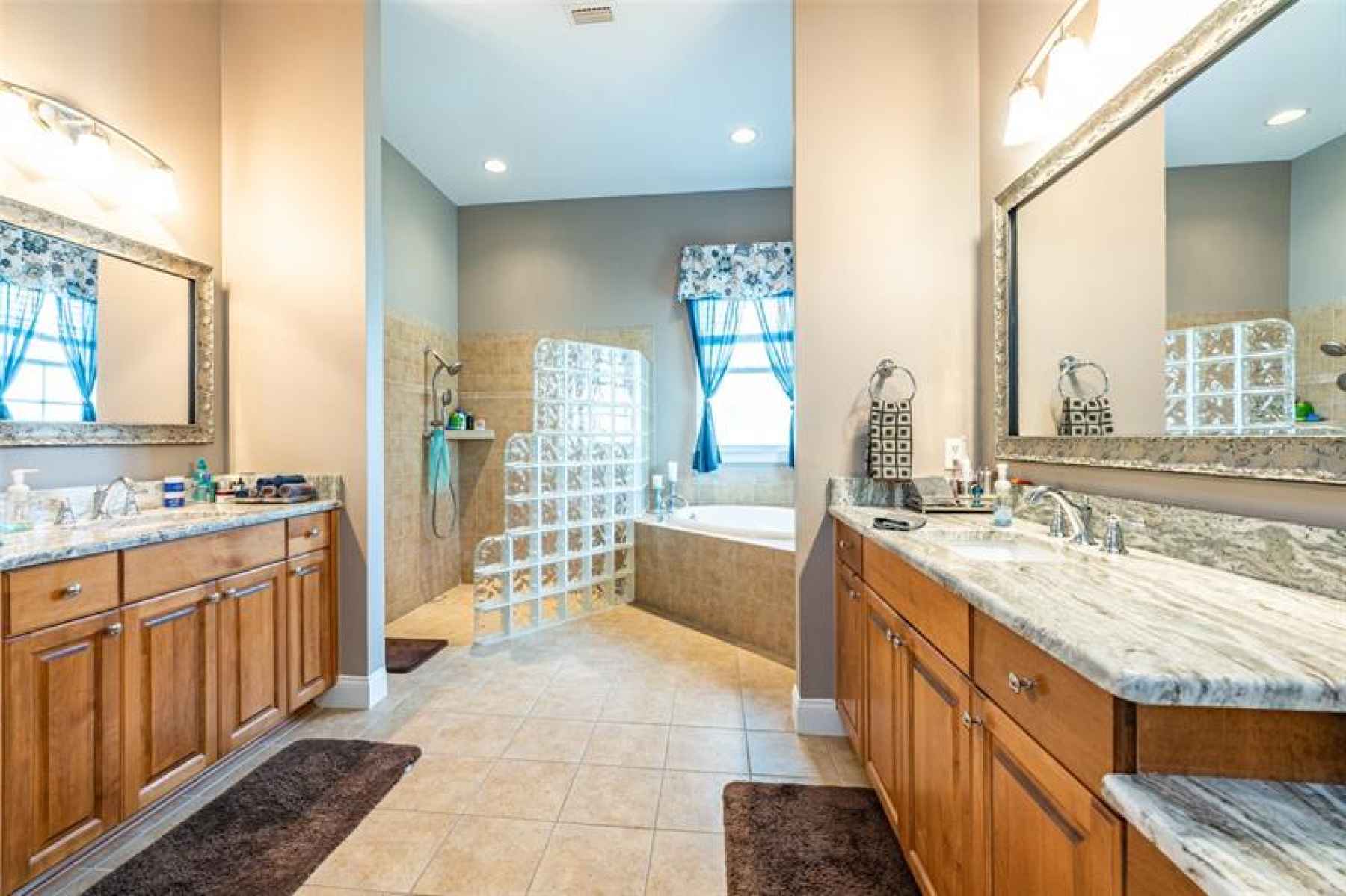 Master bath with separate vanities, garden tub, and walk in shower.