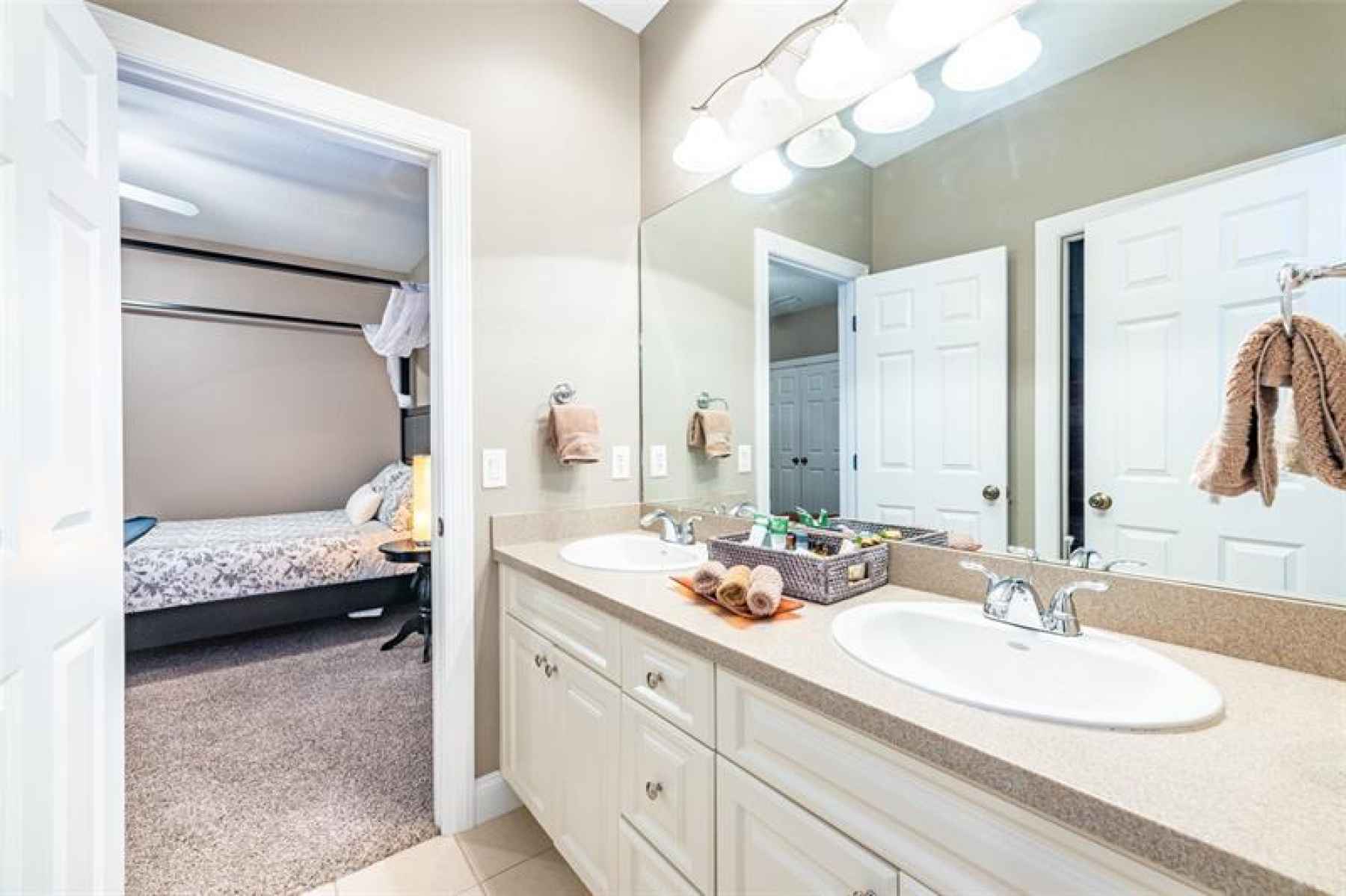 The jack and Jill bathroom located between bedrooms 3 and 4 has dual sinks, and separate tub with sh