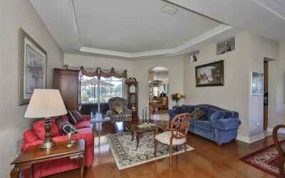 Upgraded tray ceiling compliments with real wood floor in formal living and dining room area.