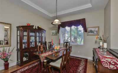 Formal dining room and real wood floor and tray ceiling.