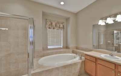 Impressive master bath with valuted ceilings, soaking tub, dual vanities and walk-in shower.