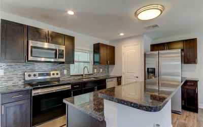 Updated Kitchen with newer Stainless Steel appliances and Eat At Island with Bar