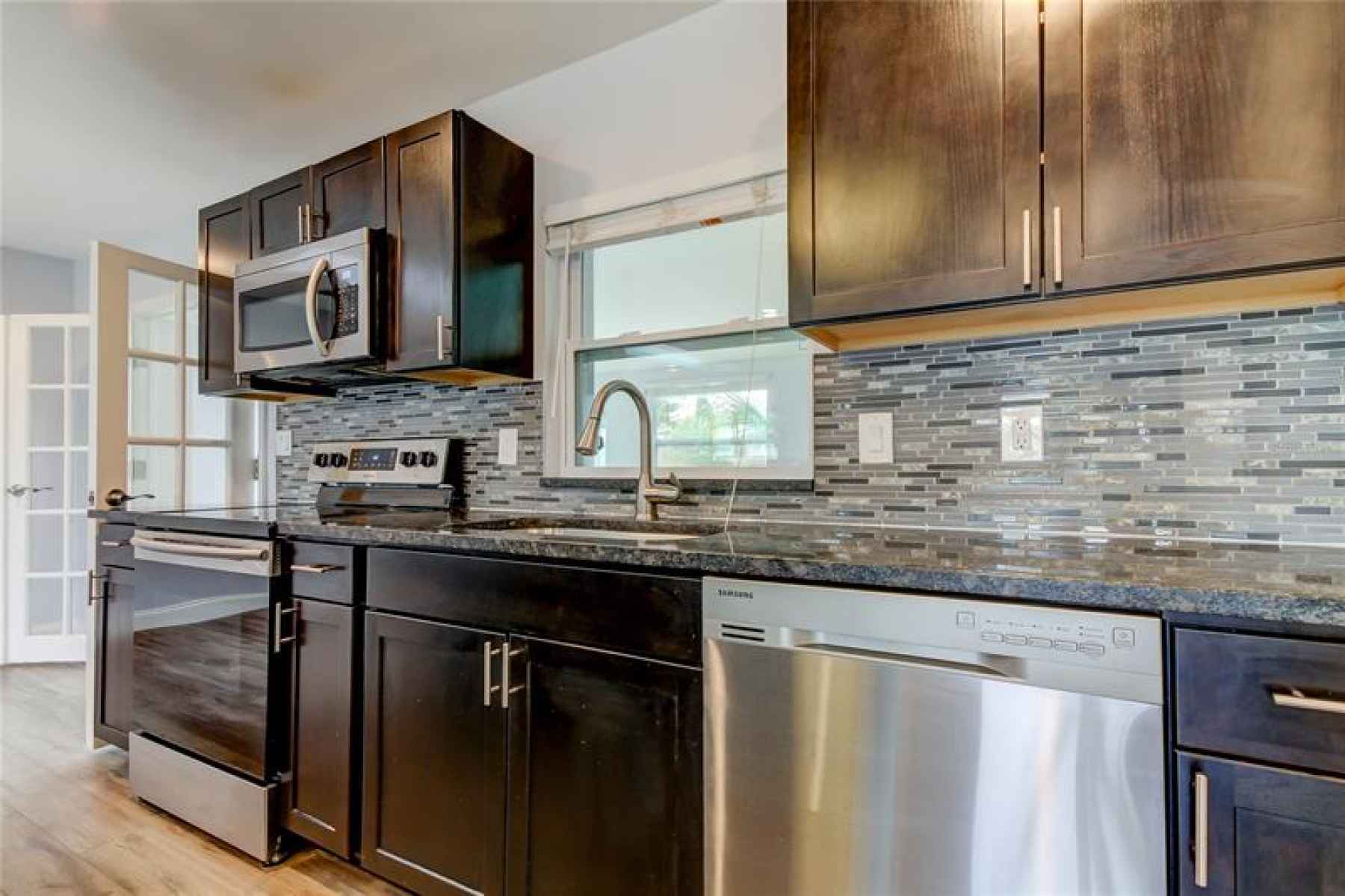 Open Kitchen with newer appliances, Tiled backsplash