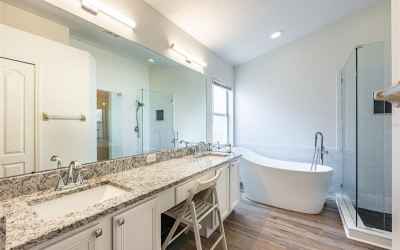 Newly remodeled master bath has granite counters with dual sinks, a soaking tub, separate shower and
