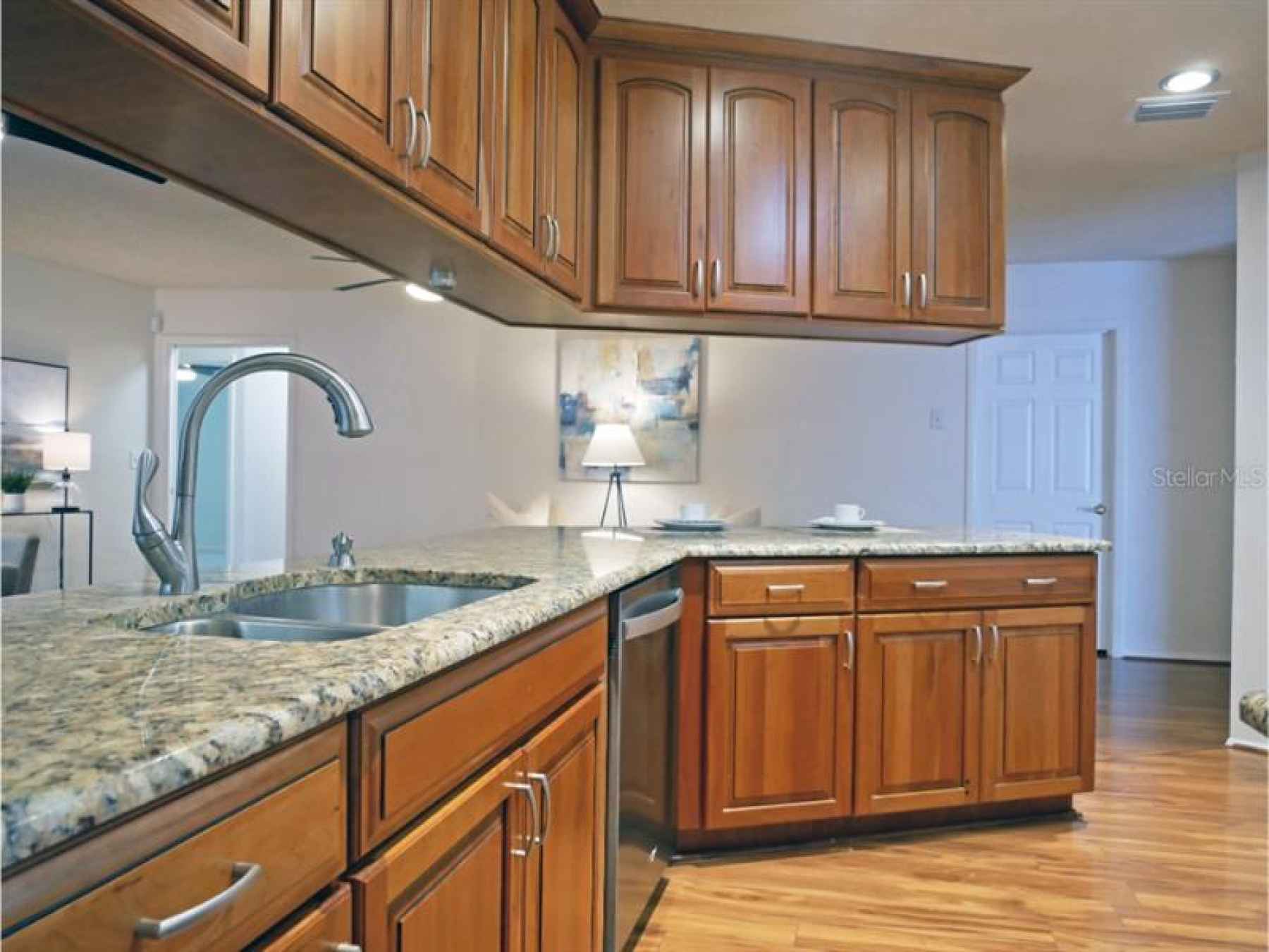 Kitchen, updated with wood cabinetry and granite countertops.