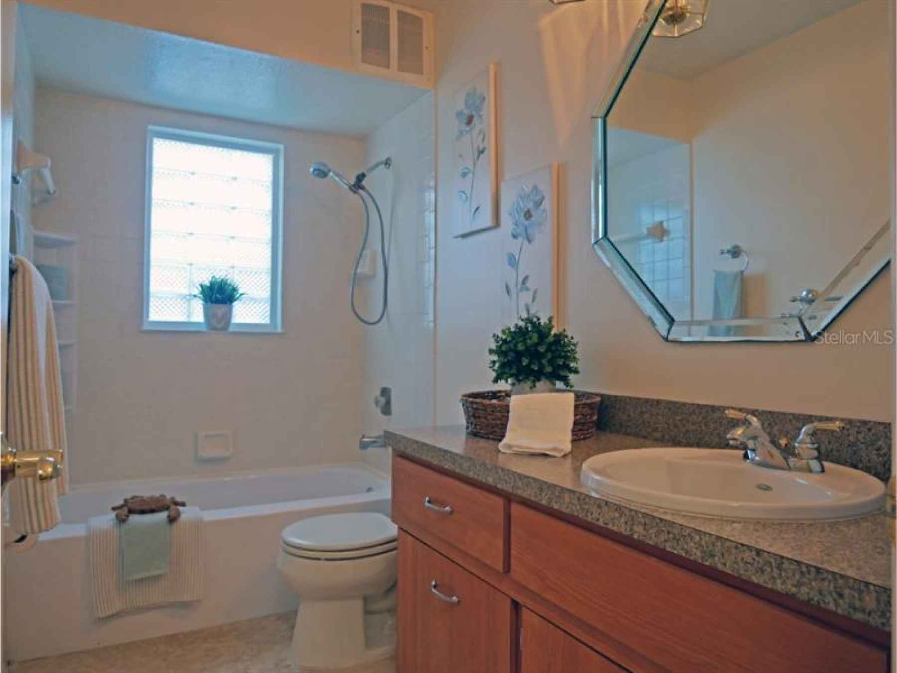 This updated bathroom is in the hall and in between the 3rd and 4th bedrooms