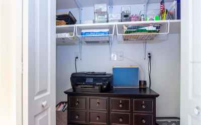 Hall closet used as an office supply area