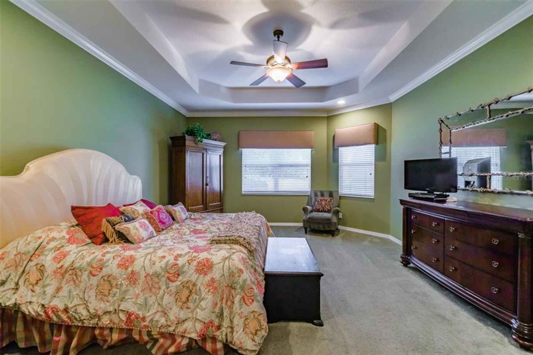 Master Bedroom Suite features a Tray Ceiling, crown molding, bay window, two walk-in closets and a f