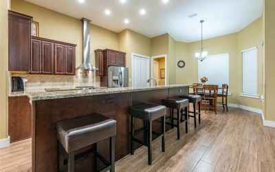 Granite counters and staining steel appliances along with eat in dinette area.
