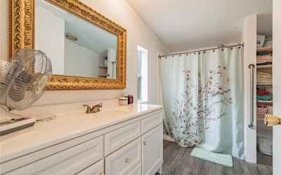 Master bedroom with updated vanity and cabinets.  Grab bar for the shower.