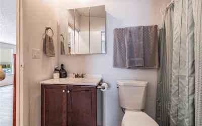 Guest bathroom with tub/shower combination and two separate doors, one to hallway for visitors and a