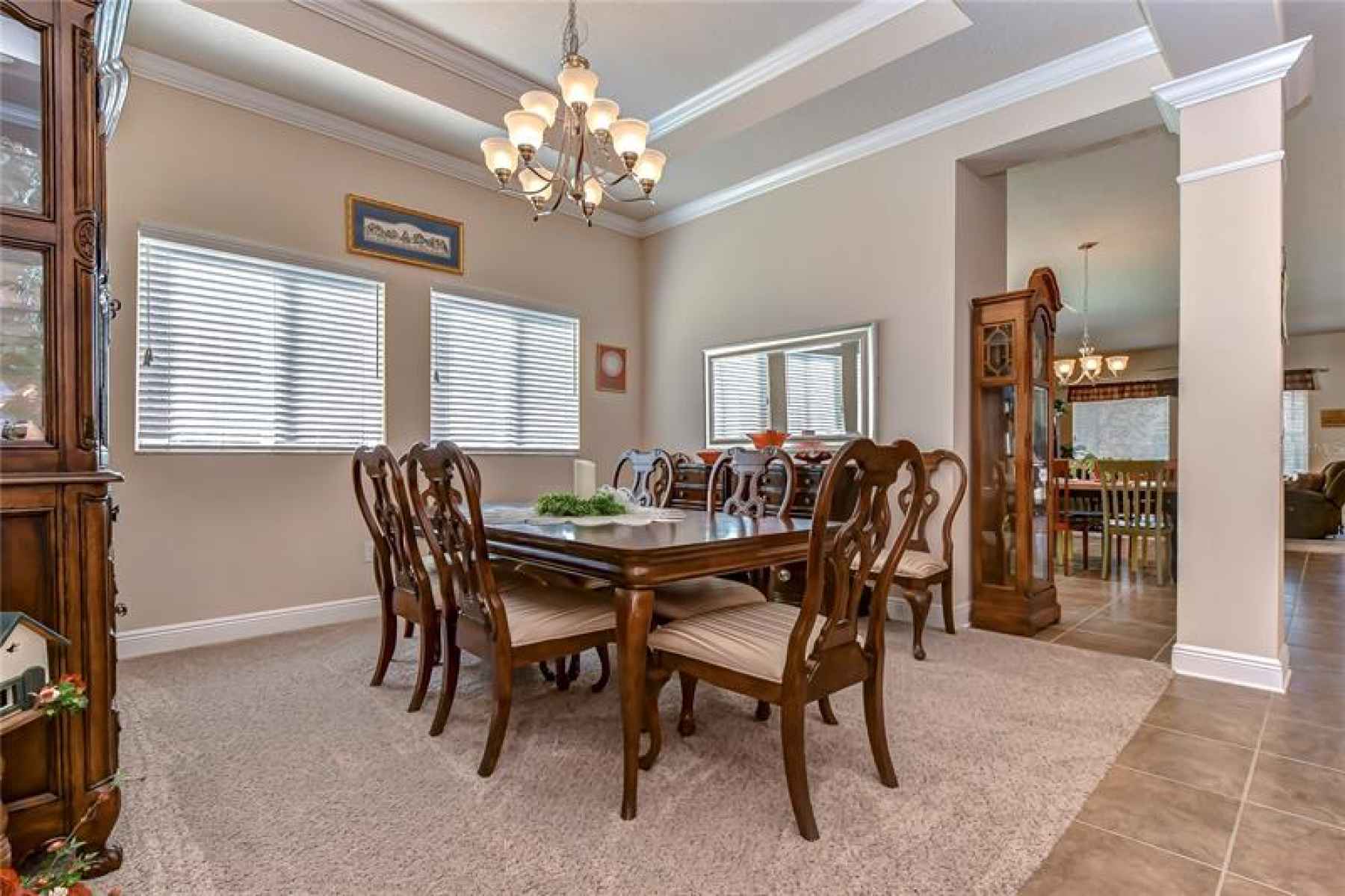 The formal dining room on the left offers a tray ceiling with crown!