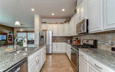 Granite counters and designer cabinets topped with crown!